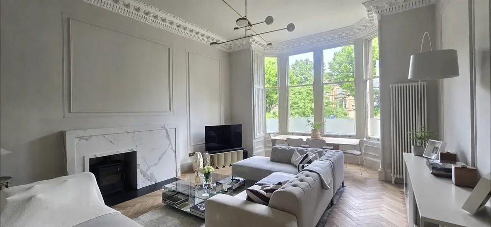 Finished period living room with ornate cornicing and bay sash window