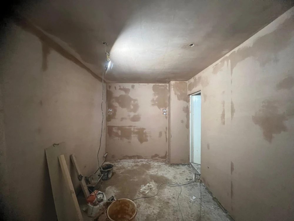 Ceiling finished, walls patch-bonded ahead of the finish coat
